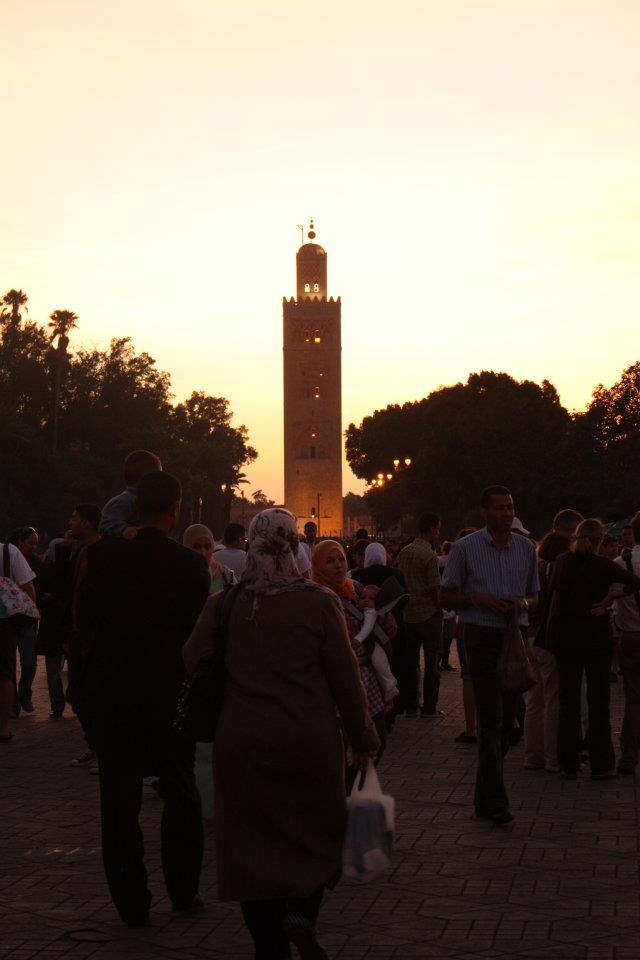 The minaret of the mosque stands proudly as the sun sets.